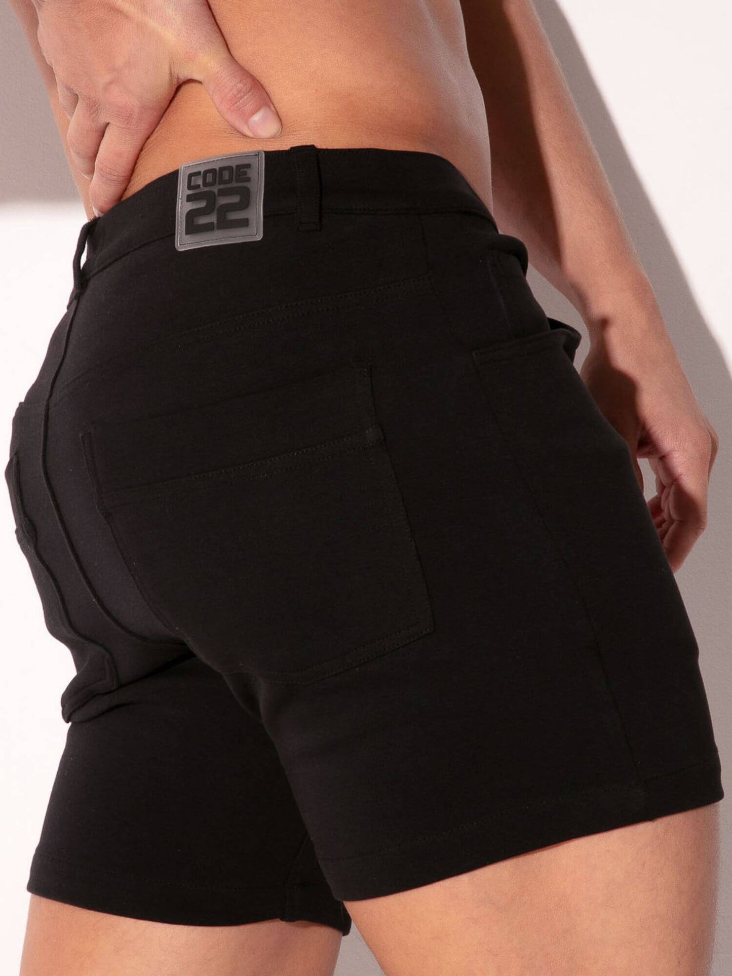 Black shorts with a visible brand logo on a plain background