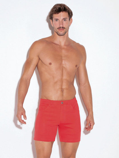 Man wearing red shorts against a white background