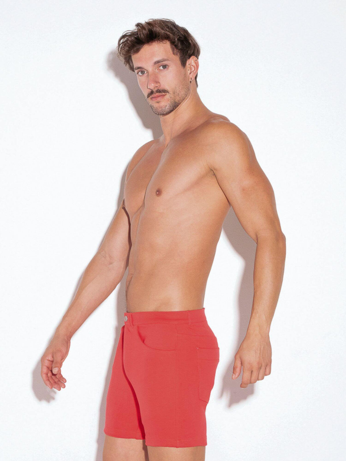 Man wearing red shorts on a white background