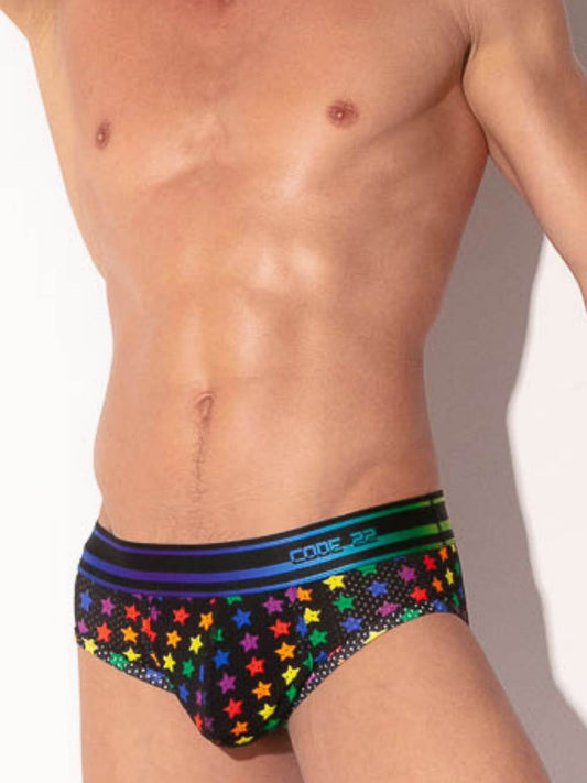Man wearing colorful star-patterned underwear with a plain background