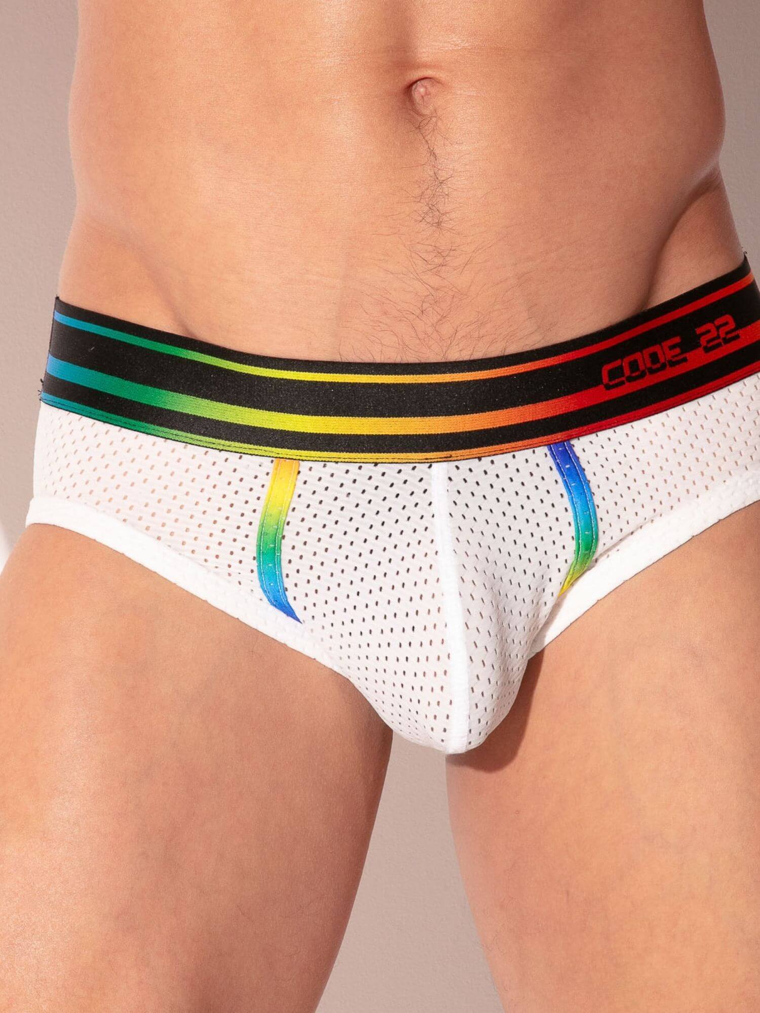 man wearing mesh white underwear with rainbow striped waistband 