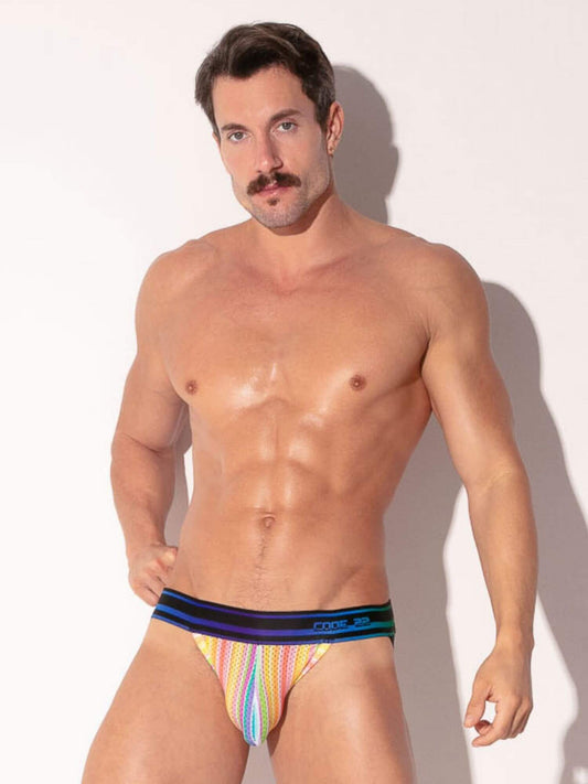 Man wearing colorful striped underwear against a plain background