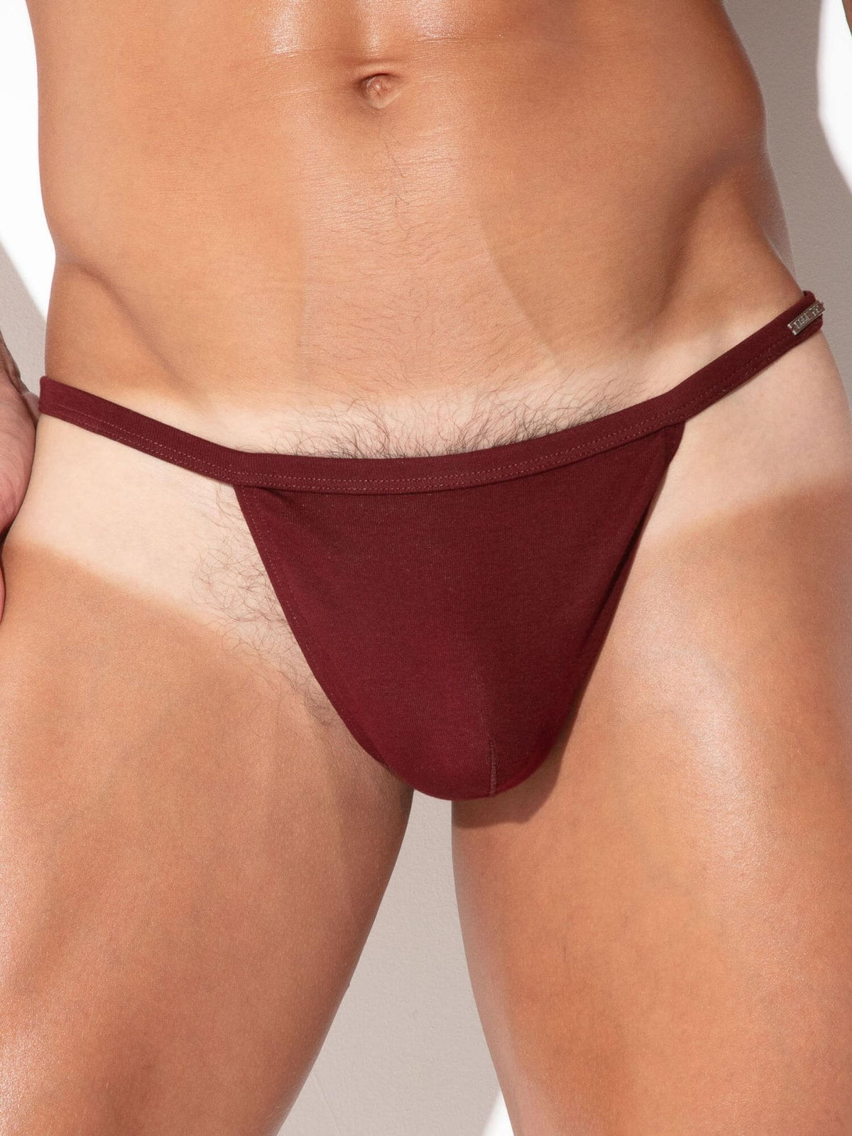 Close-up detail of CODE 22 Pure String men's underwear in maroon