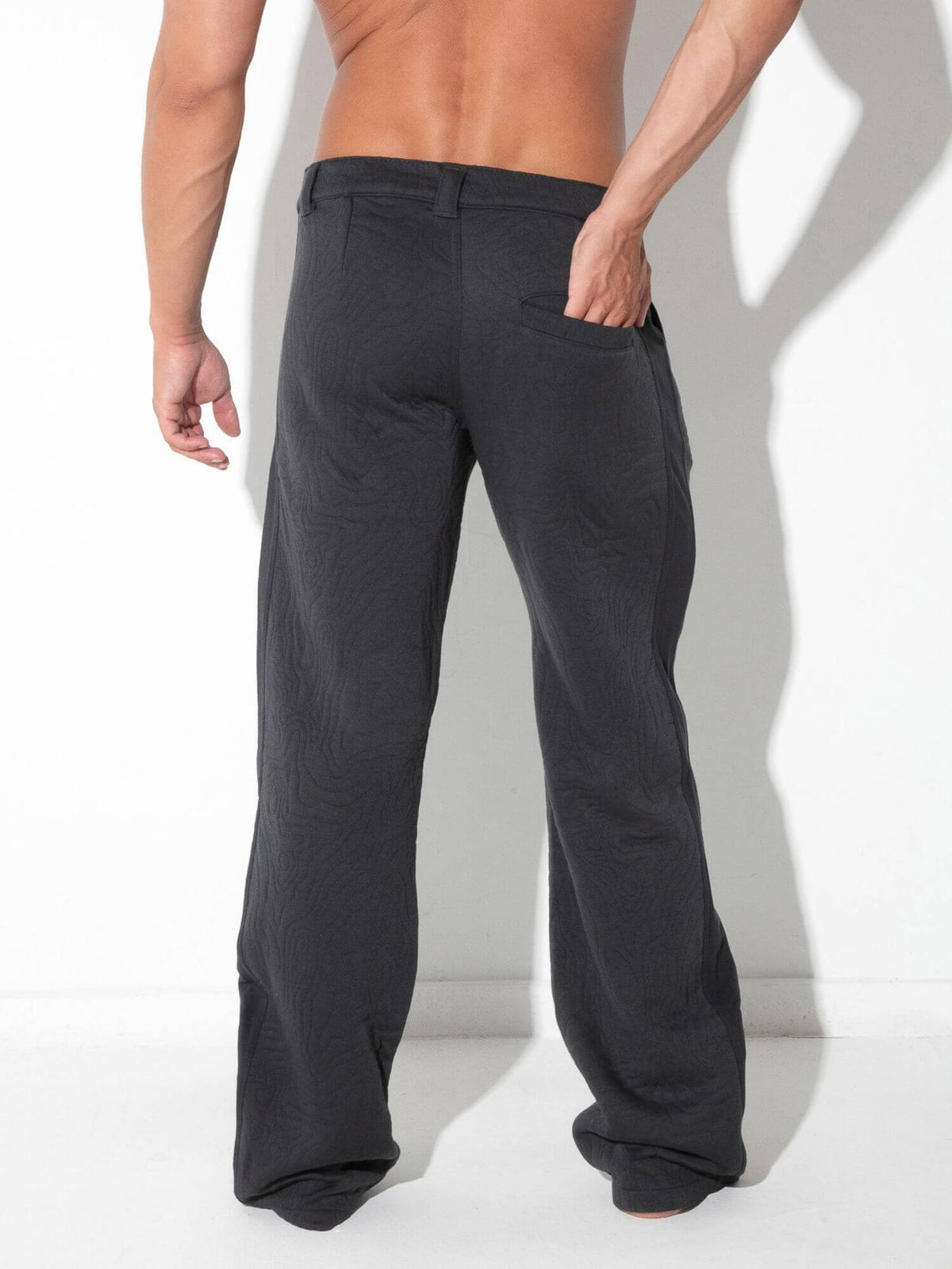 Rear view of CODE 22 Quilted Snap-Detail Pants in charcoal