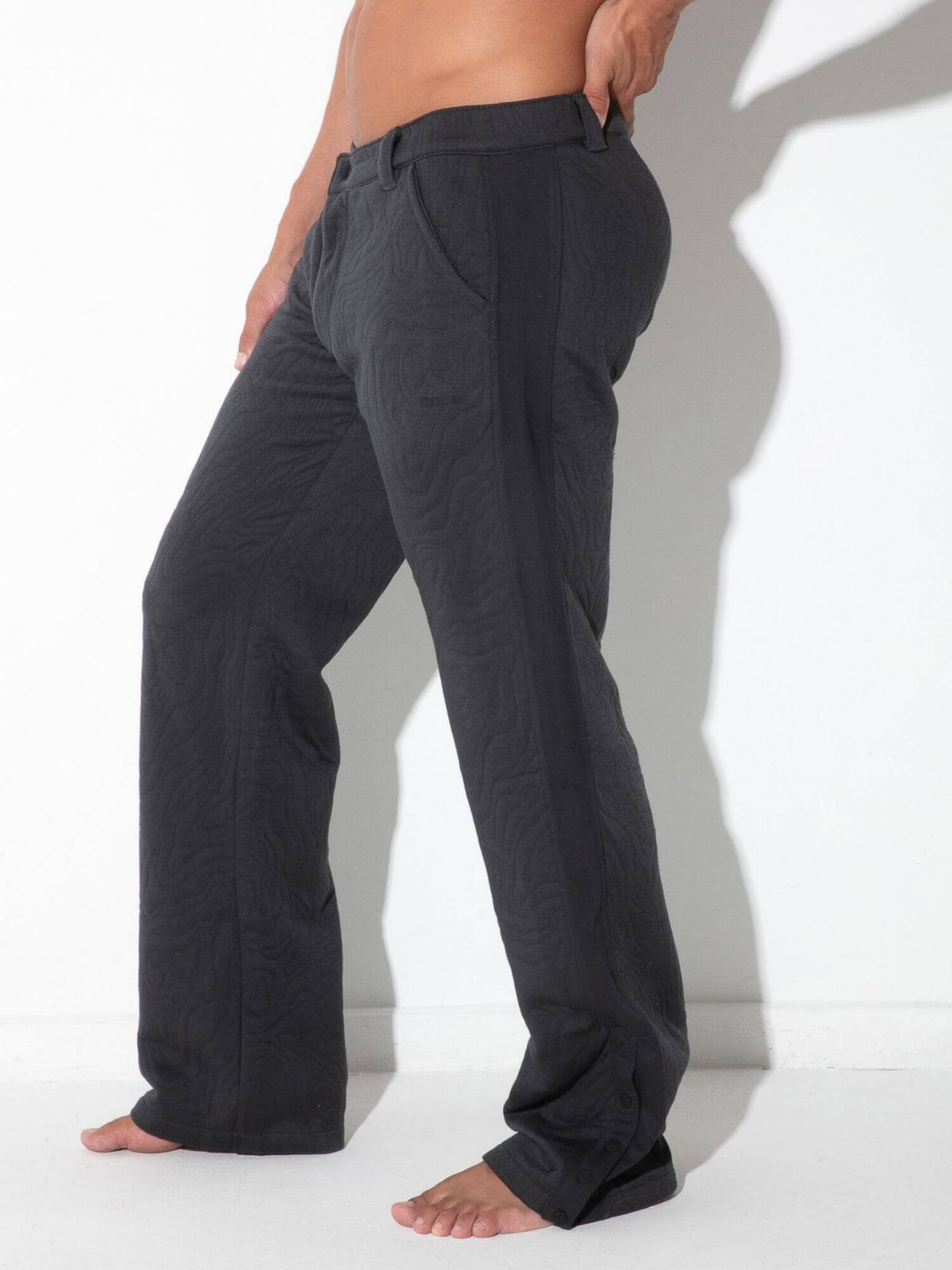 Side view of CODE 22 Quilted Snap-Detail Pants in charcoal