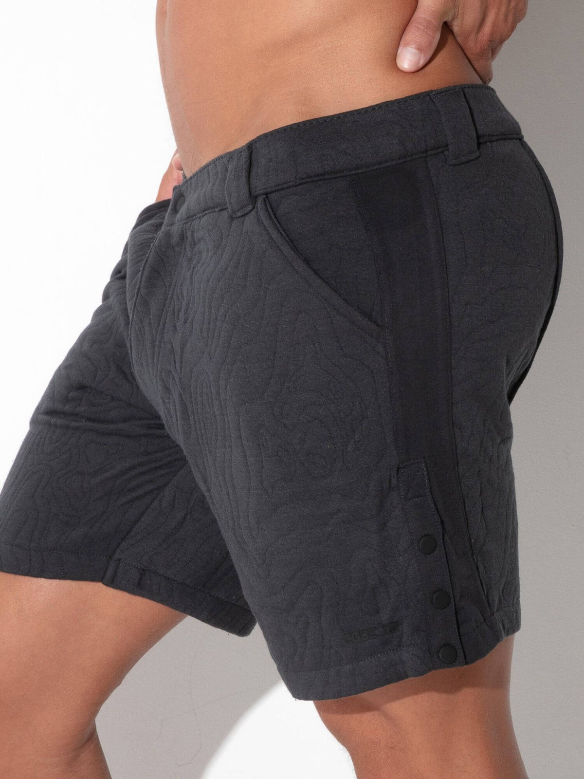 Close-up detail of CODE 22 Quilted Snap-Detail Shorts in charcoal