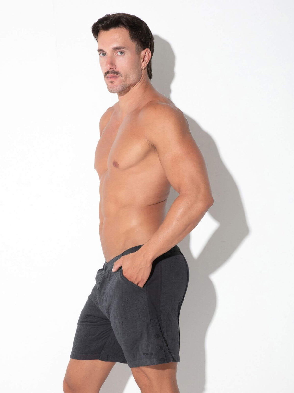 Side view of CODE 22 Quilted Snap-Detail Shorts in charcoal