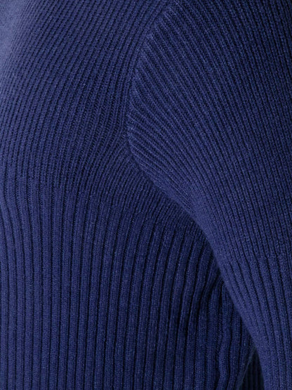 Close-up of a dark navy blue ribbed knit fabric, showing the detailed vertical ribbing texture.