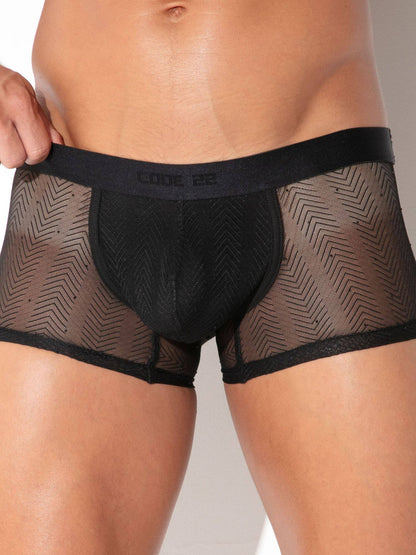 A close-up of a model wearing black mesh boxer briefs with a solid black pouch and waistband. The brand name 'CODE 22' is printed on the waistband.