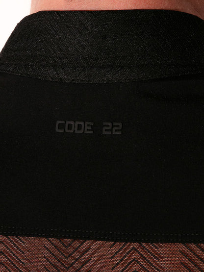Close-up of a black garment with 'CODE 22' branding.