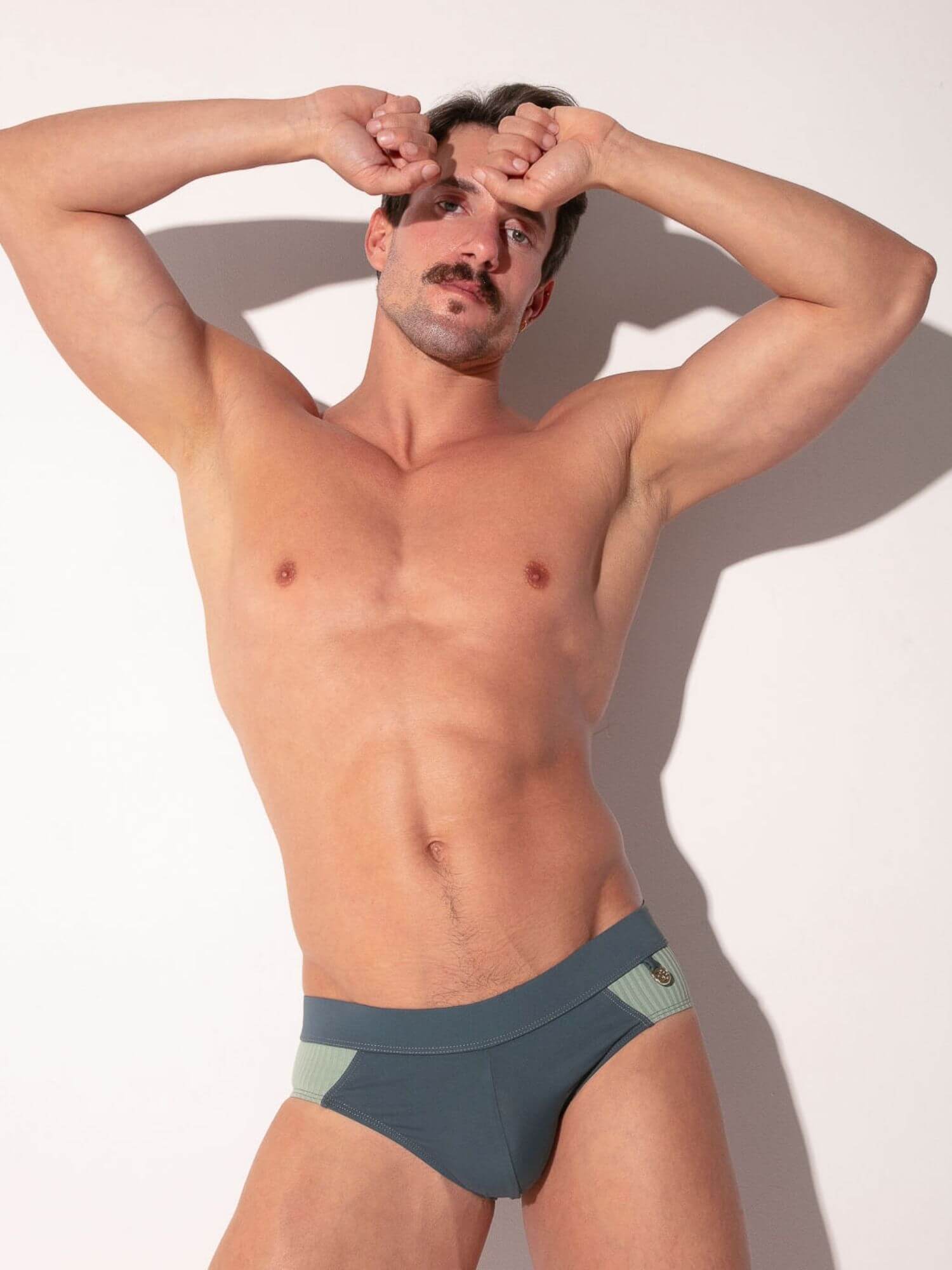 Man wearing a grey & green swimming brief  