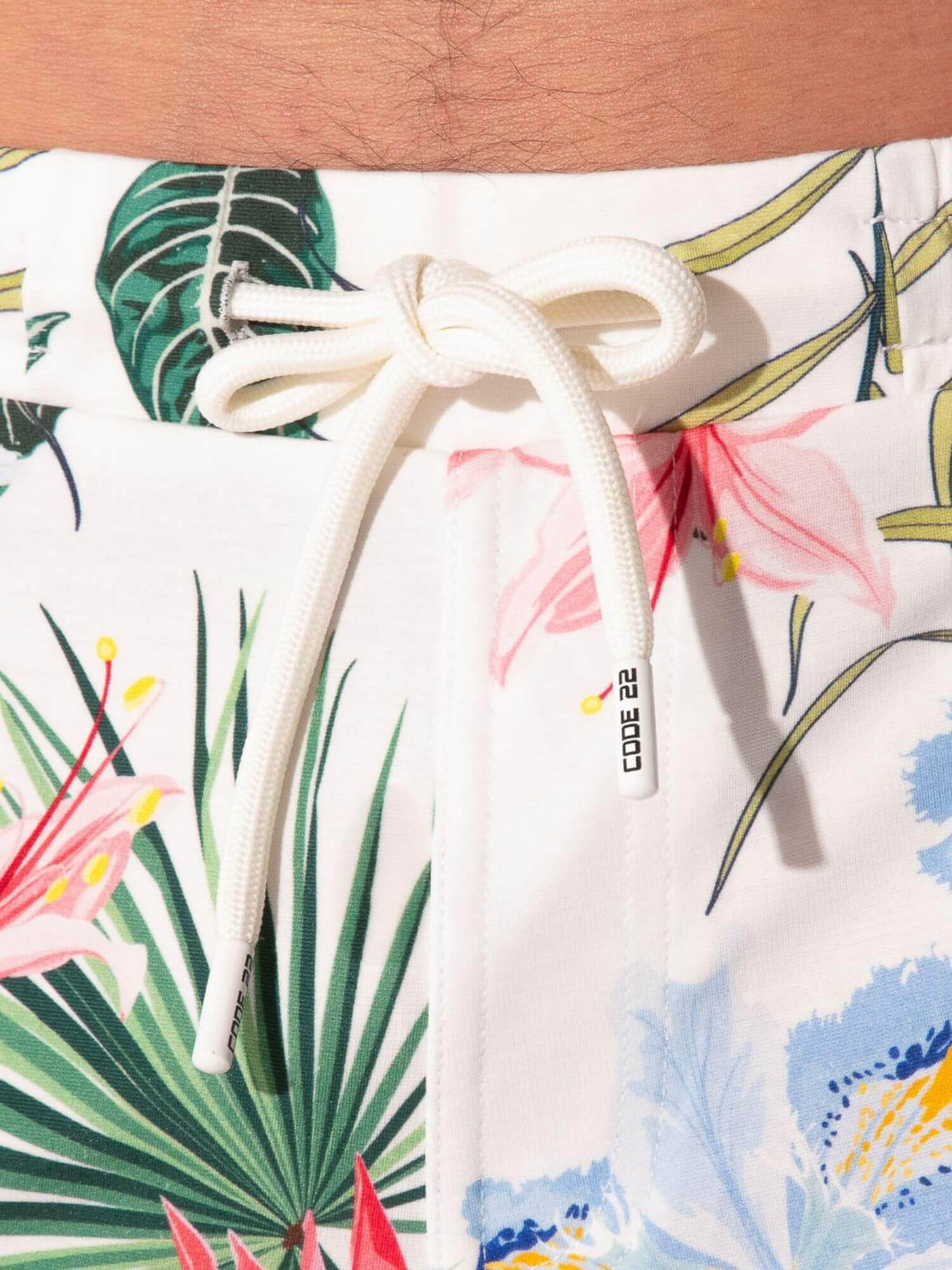 Tropical floral patterned shorts with a drawstring and visible brand logo.