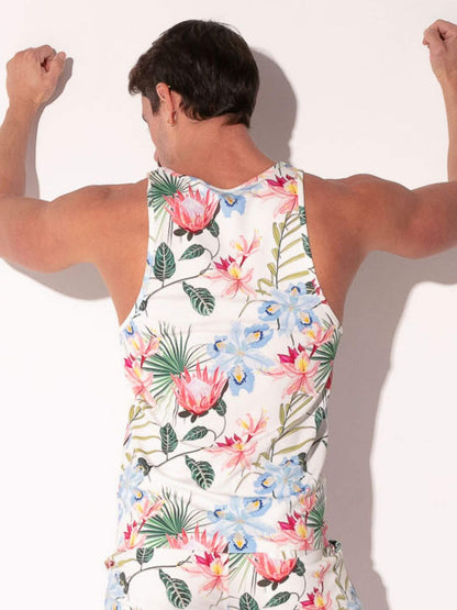 Person wearing a colorful floral tank top against a plain background