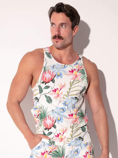 Man wearing a colorful floral tank top against a plain background