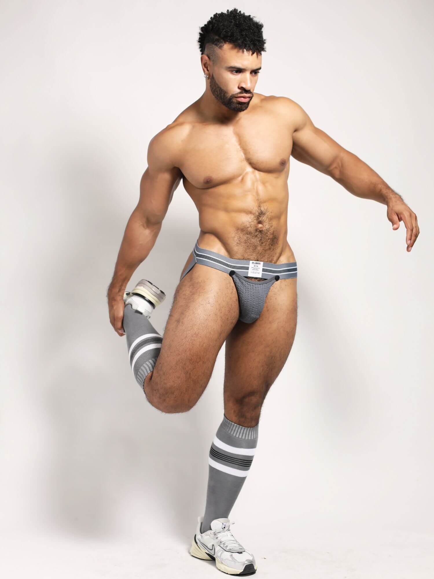 Man wearing gray underwear and socks on a white background
