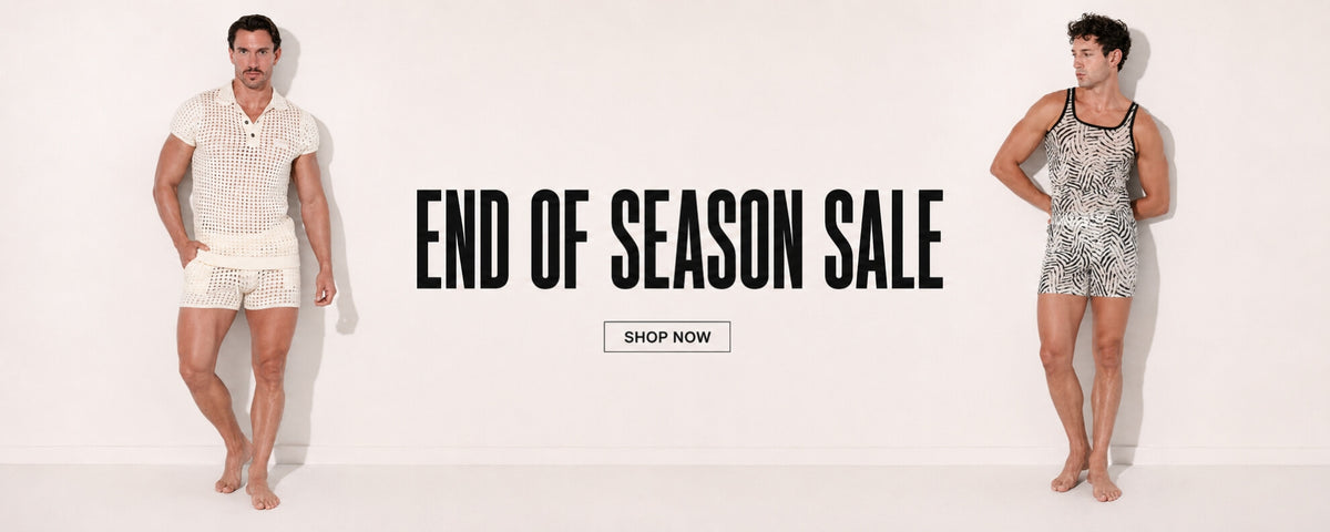 A promotional banner for an end of season sale, featuring a man on the left in a white patterned short-sleeve shirt and shorts, and a woman on the right in a black and white patterned tank top and shorts. The center features the text 'END OF SEASON SALE' and a 'SHOP NOW' button.