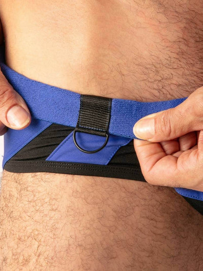 Person adjusting a blue waist trainer with black straps.