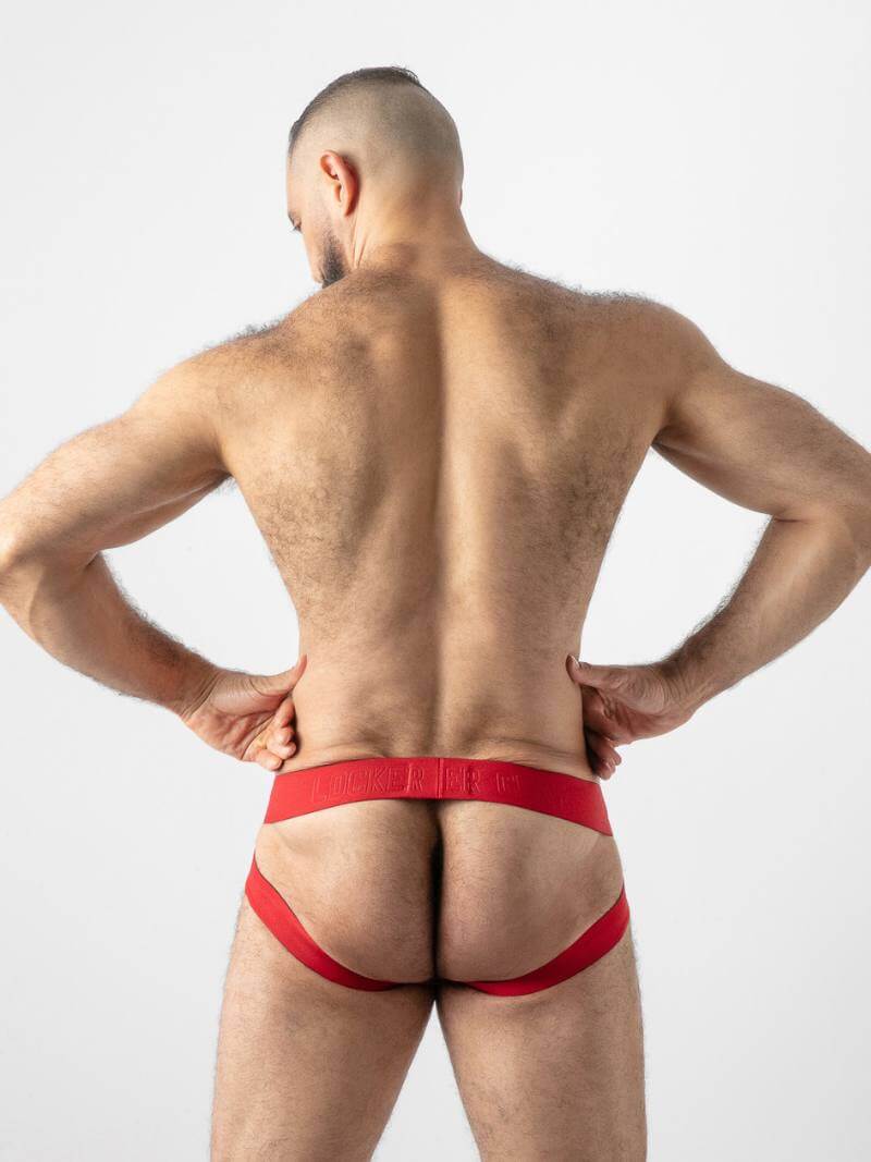 Man wearing red underwear on a plain background