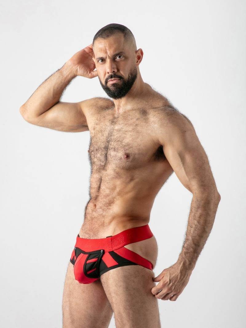 Man wearing red underwear with a black design on a white background