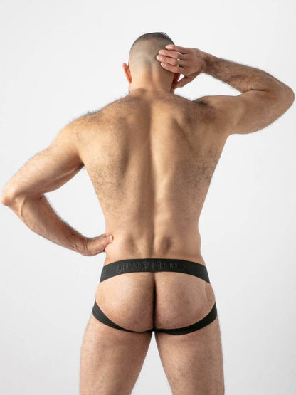 Man wearing black underwear with a plain background