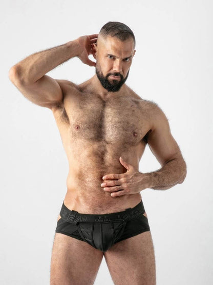 Man wearing black underwear against a white background