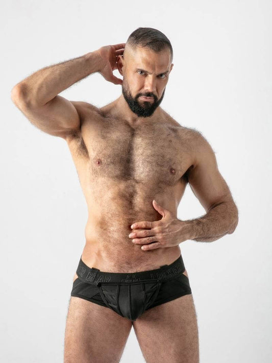 Man wearing black underwear against a white background