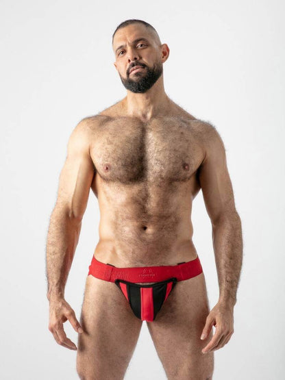 Man wearing a red and black jockstrap on a white background