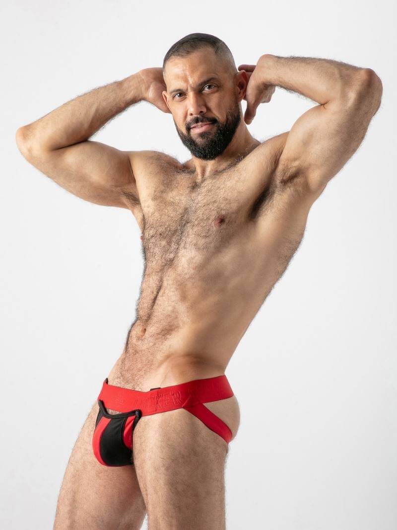Man wearing red and black athletic underwear against a white background