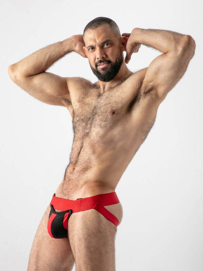 Man wearing red and black athletic underwear against a white background