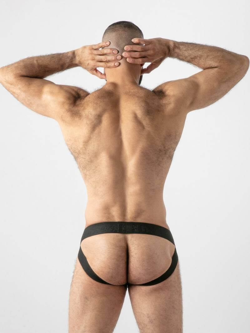 Man wearing black men's underwear against a white background