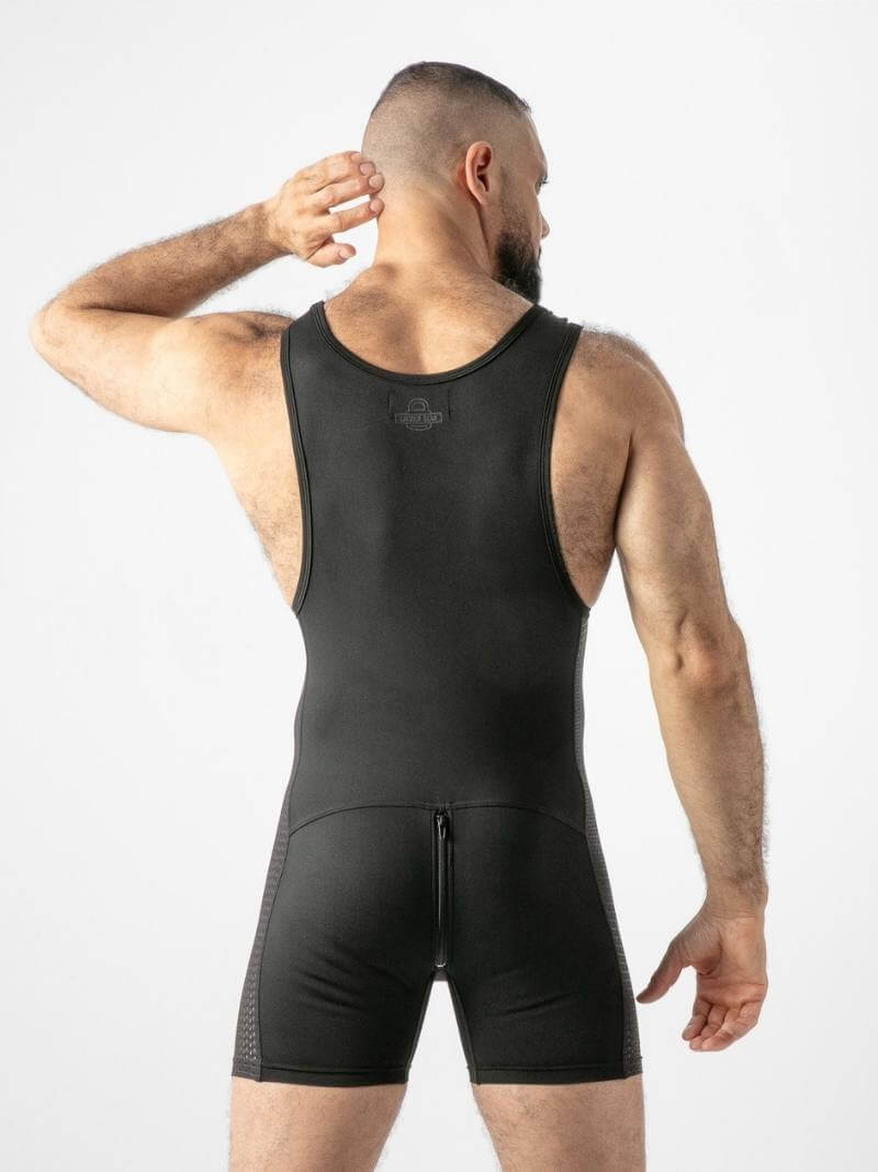 Man wearing a black compression garment on a white background