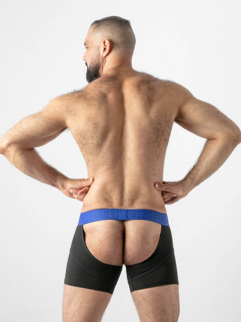 Man wearing black underwear with a blue waistband on a plain background
