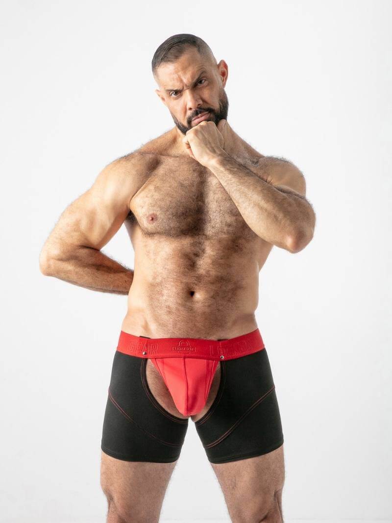 Man wearing black and red underwear on a white background