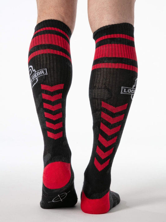 Black and red knee-high socks with a visible brand logo on a white background
