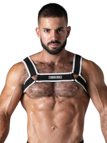 A muscular man wearing a black and white chest support harness with the brand name 'LOCKER GEAR' printed on the center band, set against a plain white background.