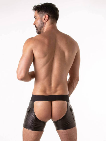 Man wearing black leatherette men's underwear on a white background