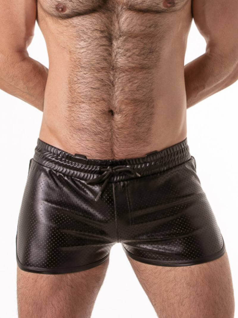 Gay black leather shorts worn by a guy on a white background