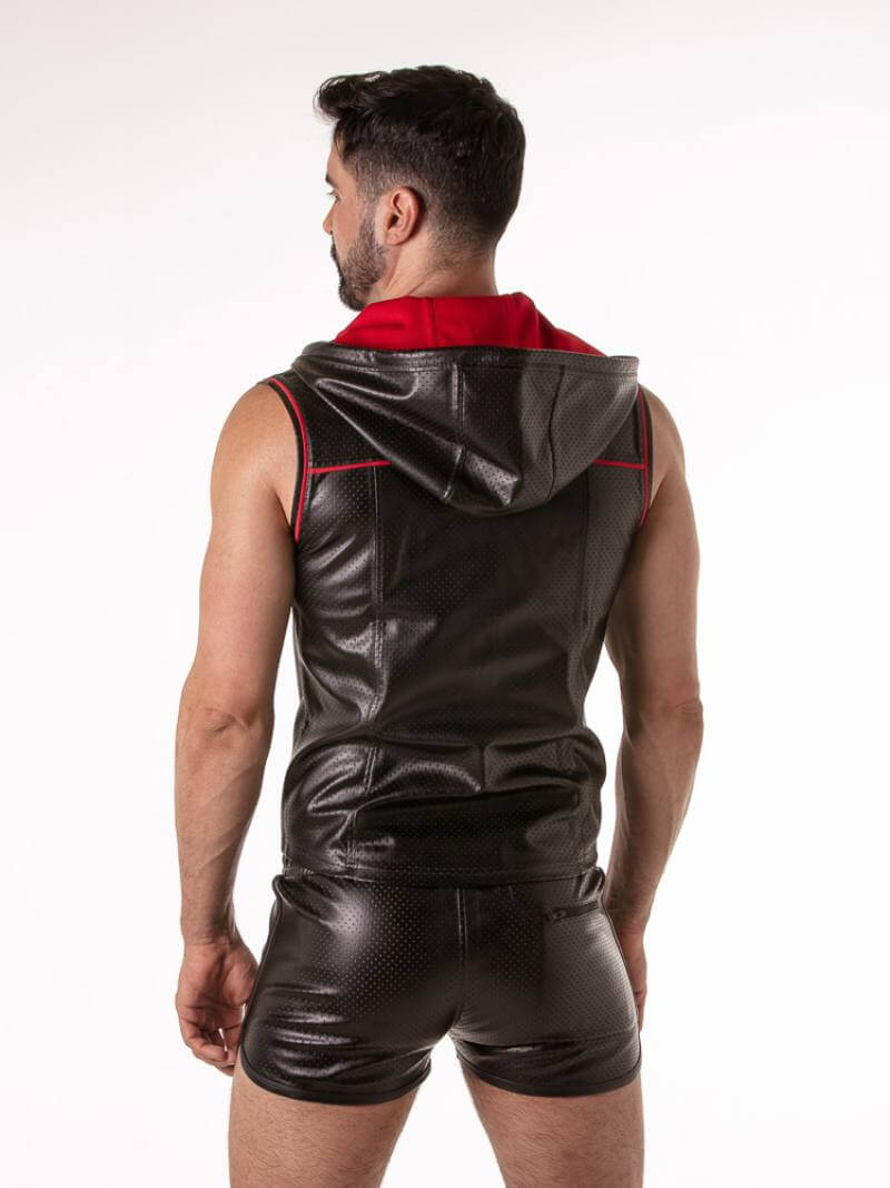 Gay guy wearing a black leather sleeveless hoodie with red accents on a white background
