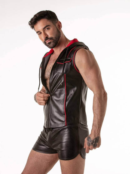 Man wearing a black leather vest with red accents and matching shorts on a white background