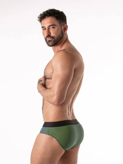 Man wearing green underwear with a white background