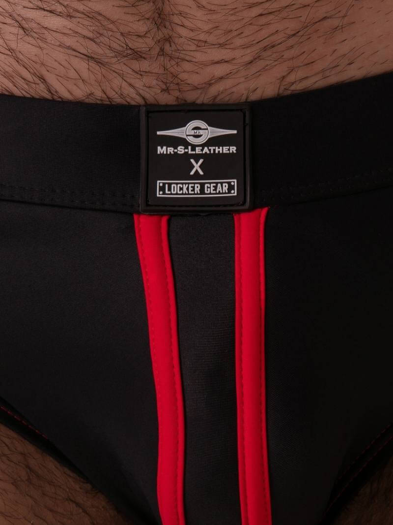 Black underwear with red stripes and a visible brand label on a skin background