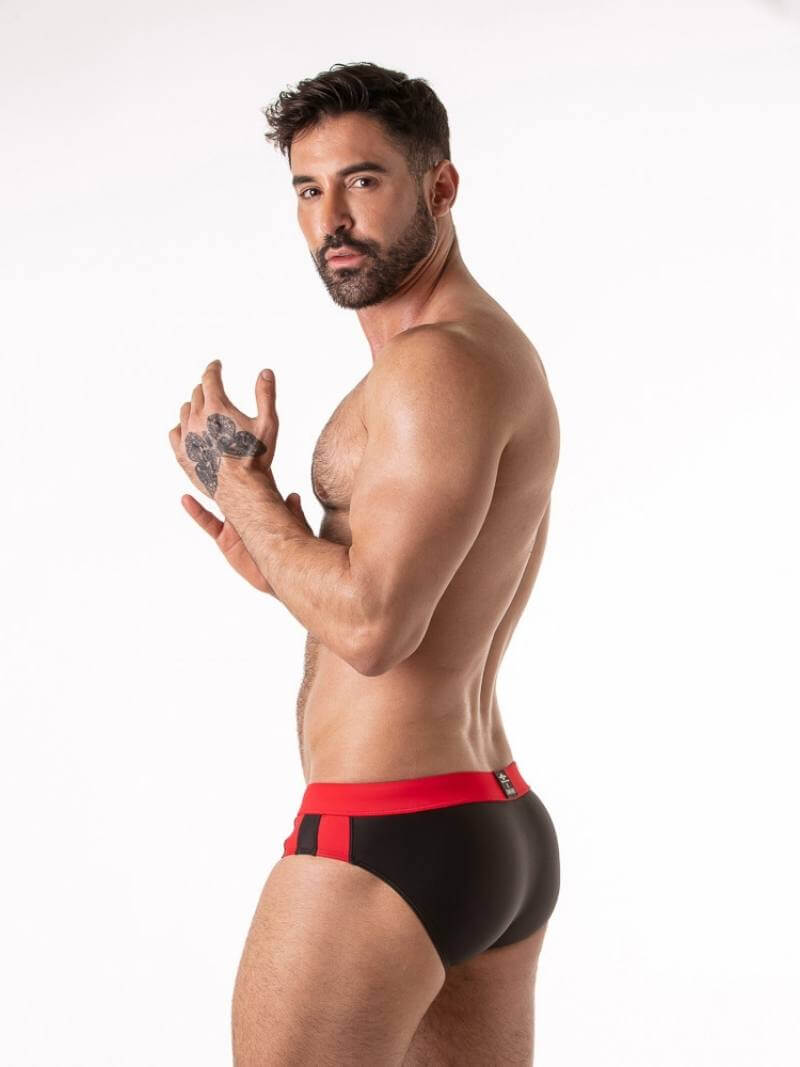 Gay man wearing black and red underwear on a white background