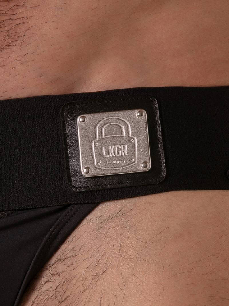 Black belt with a metallic 'LKGR' buckle on a person's waist.