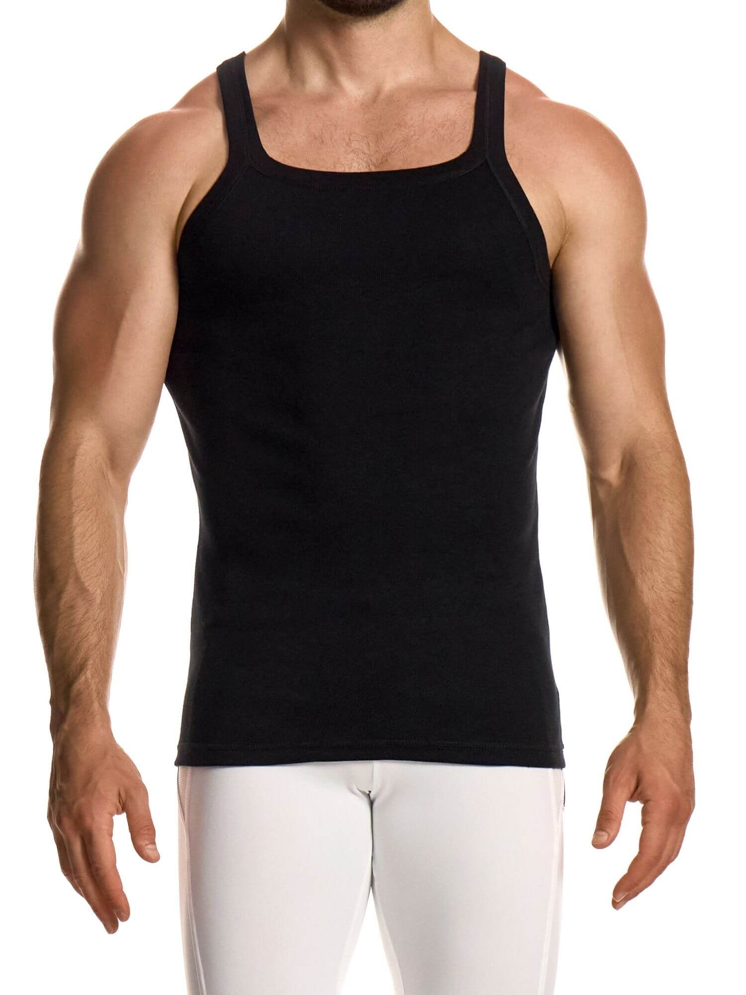 Man wearing a black tank top and white pants on a white background