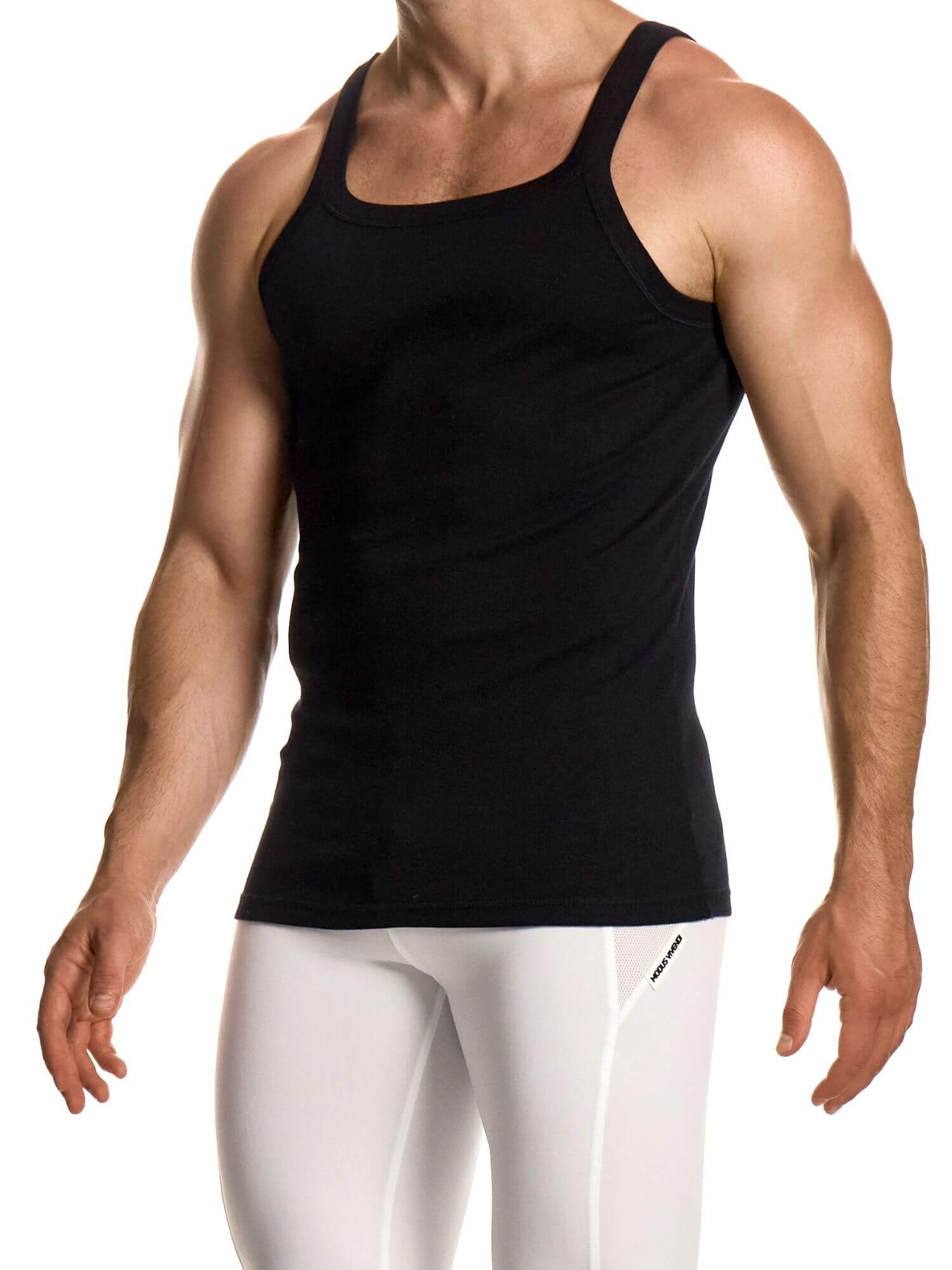 Person wearing a black tank top and white pants on a white background