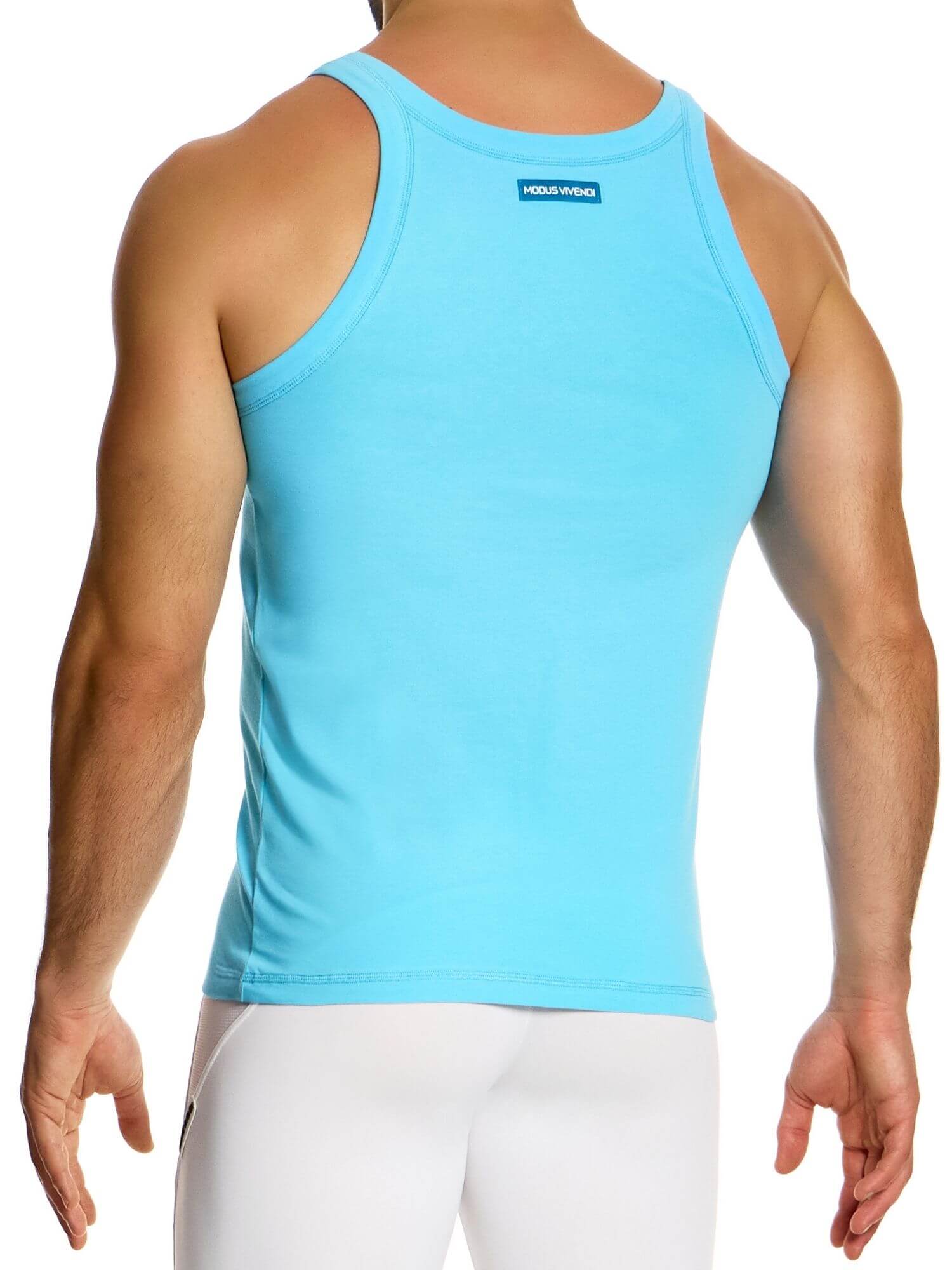 Person wearing a light blue tank top with a brand logo on a white background