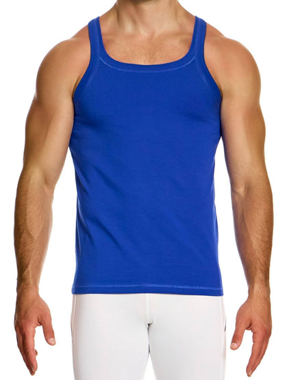 Person wearing a blue tank top and white pants on a white background