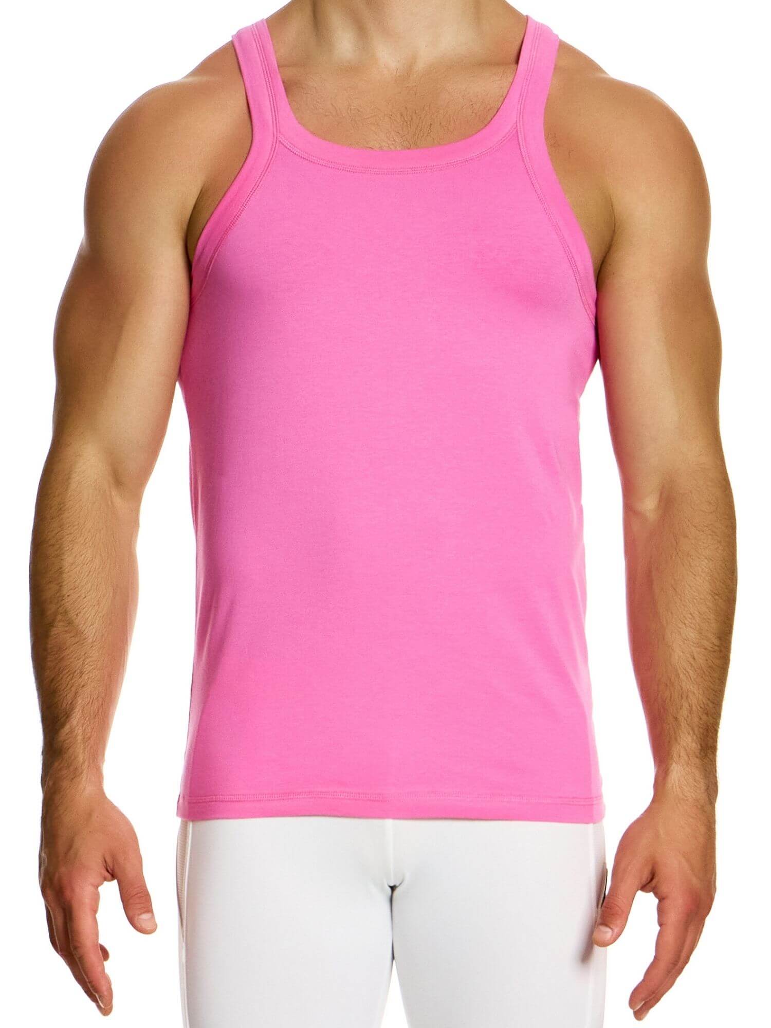 Person wearing a pink tank top and white pants on a white background