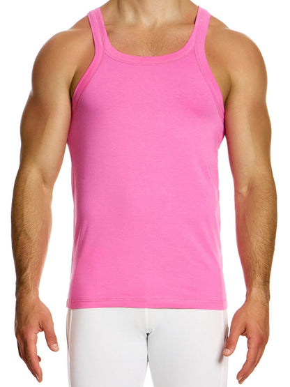 Person wearing a pink tank top and white pants on a white background