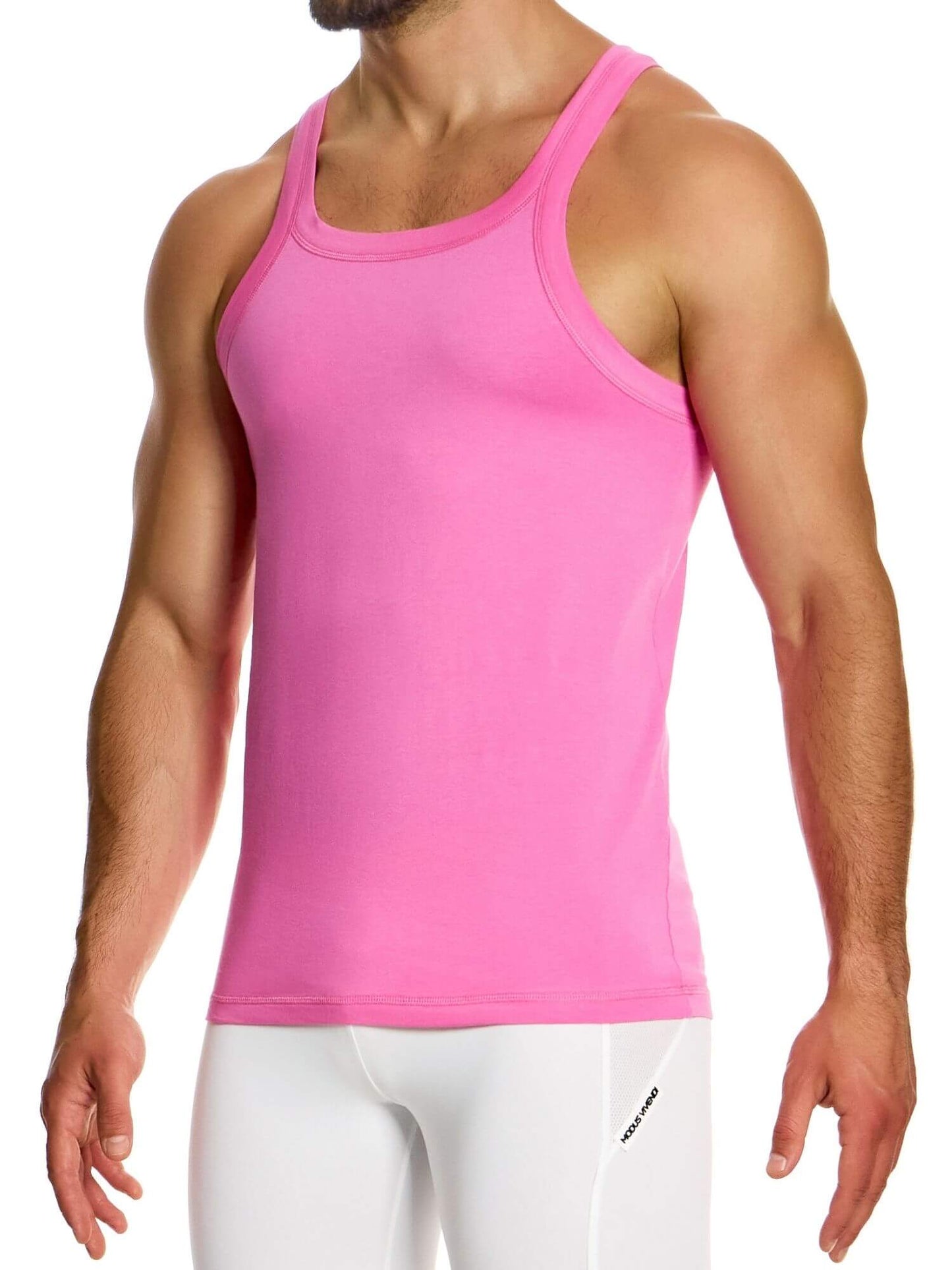 Person wearing a pink tank top and white pants on a white background